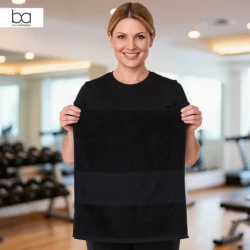 Blank Athletics Essential Gym Towel in Black with custom print, lady in gym holding towel